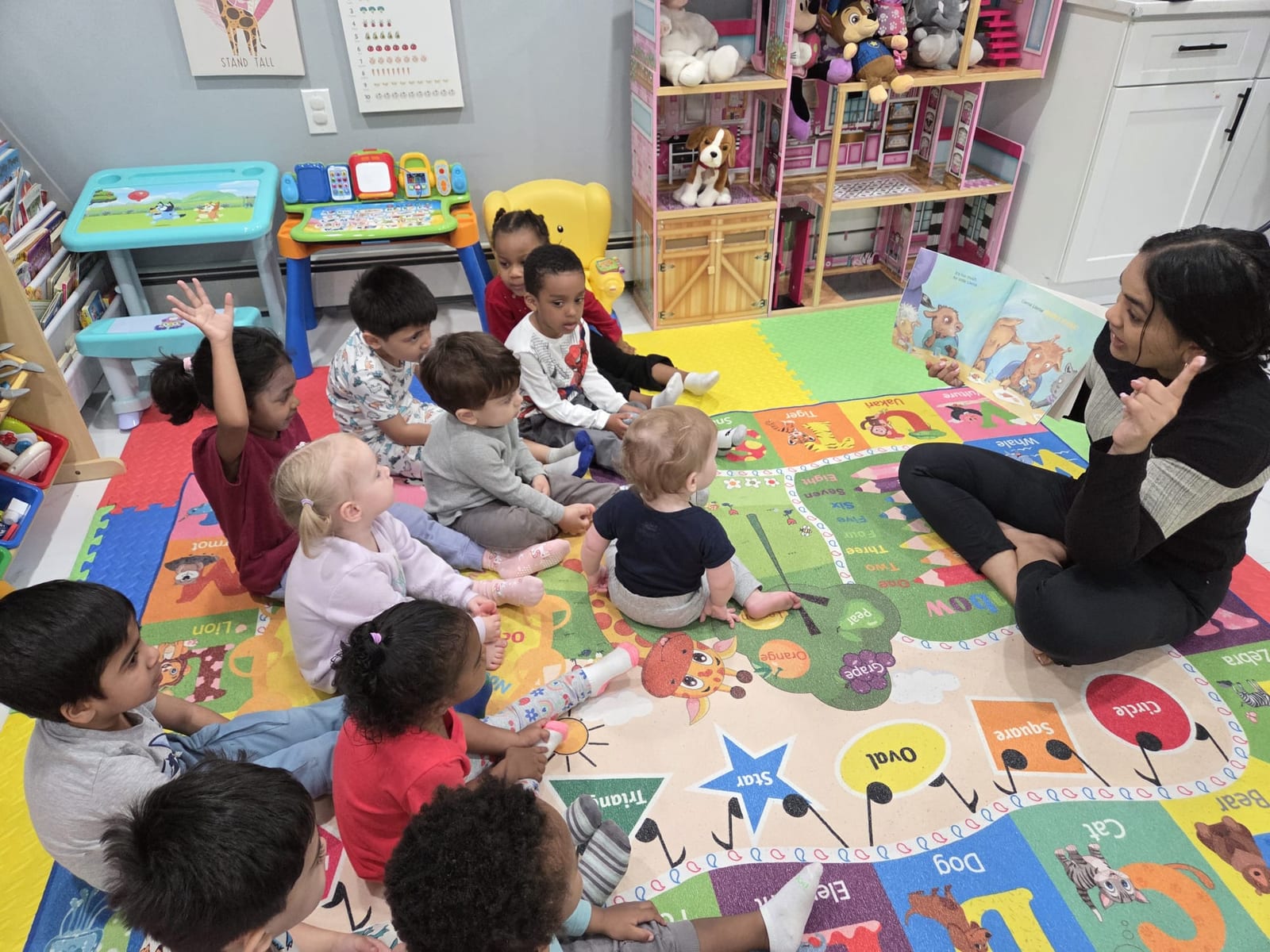 Malisa reading a book to children during story time