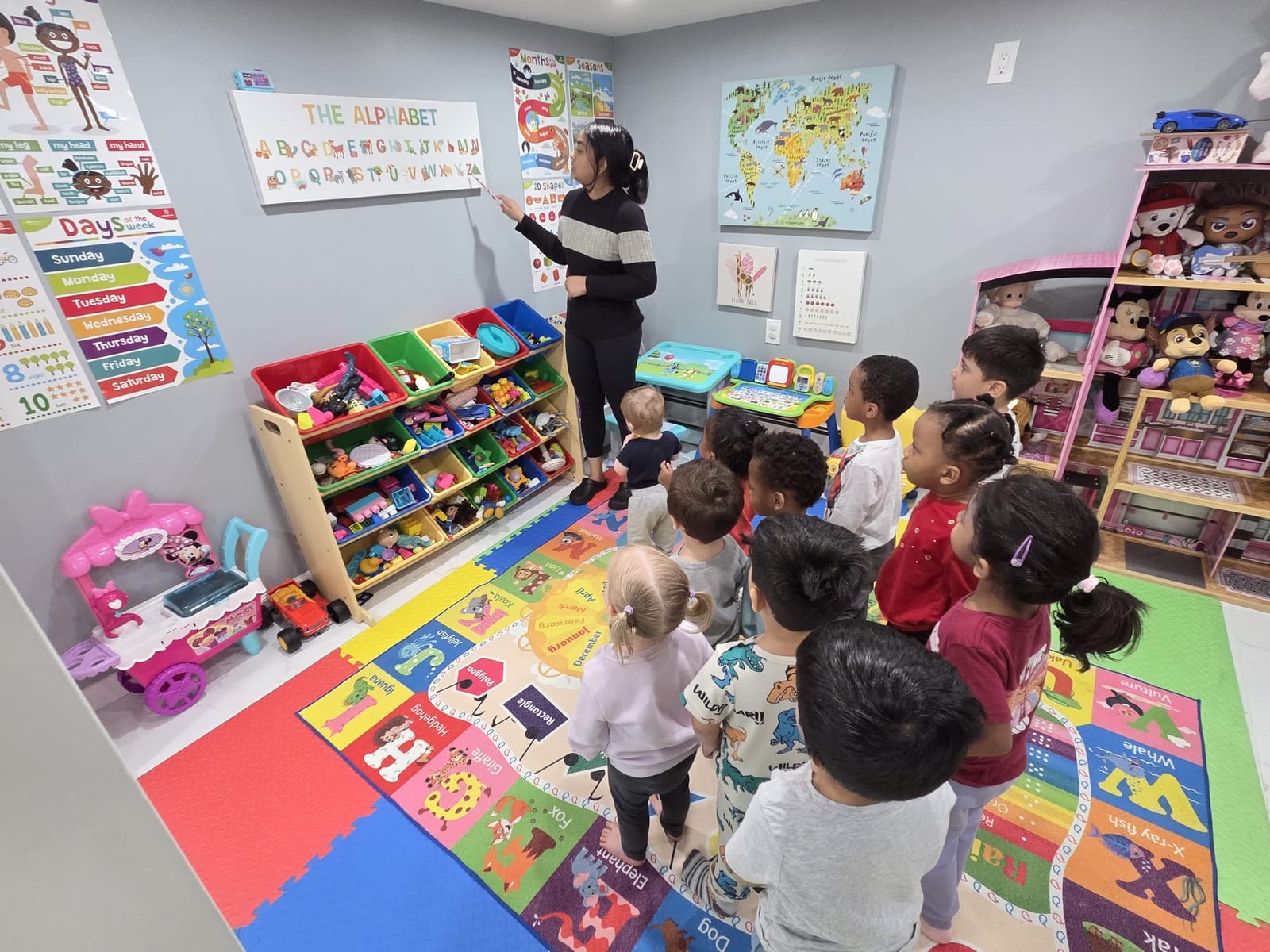 Malisa teaching the alphabet to children at Nurture and Grow Daycare