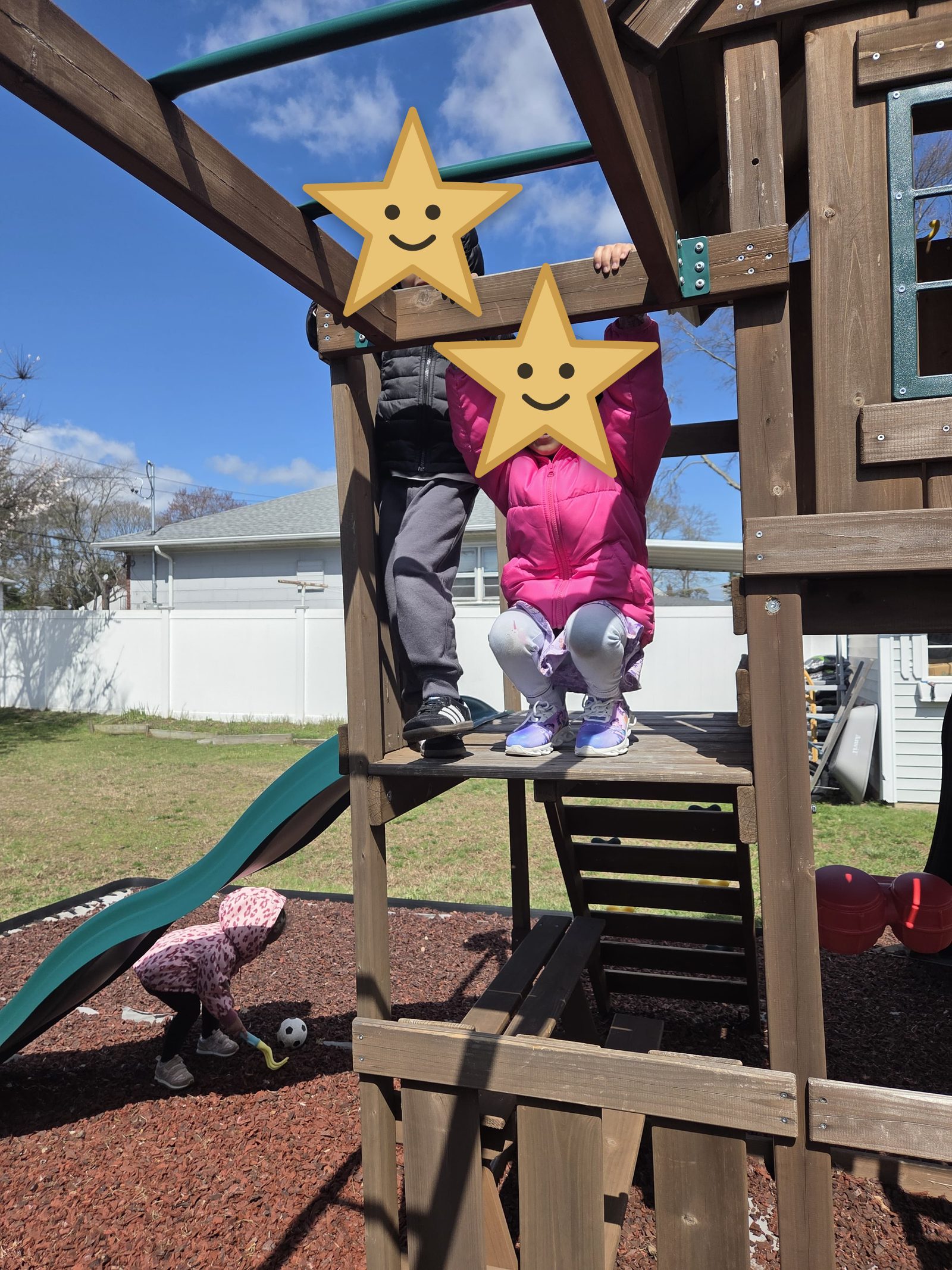 Two children climbing the monkey bars together