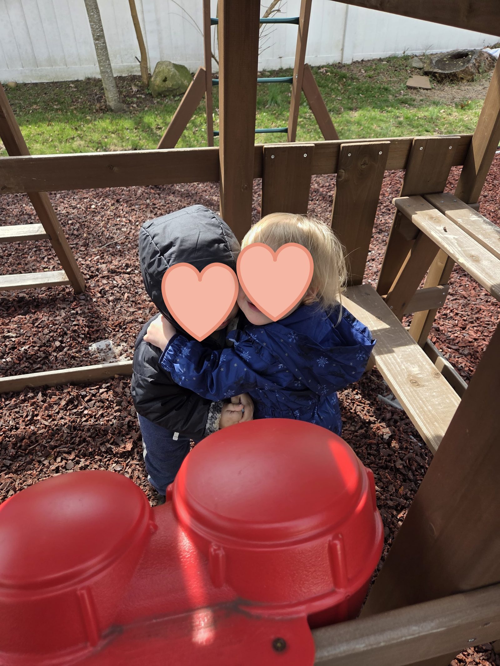 Two children sharing a hug — kindness and connection at Nurture and Grow